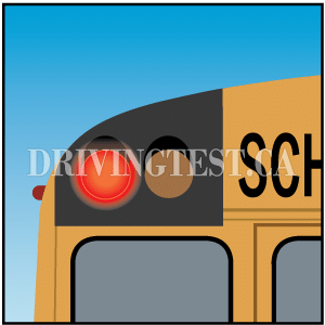 Test 1 - What should you do if you see a school bus with its flashing amber lights or hazard lights on?